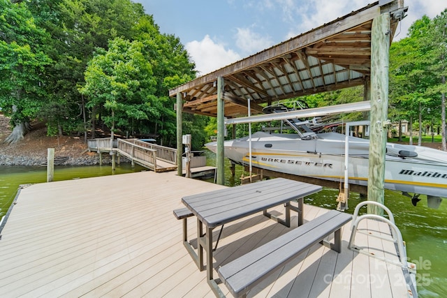 dock area with a water view and boat lift