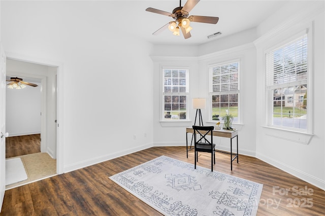 living area featuring visible vents, ceiling fan, baseboards, and wood finished floors