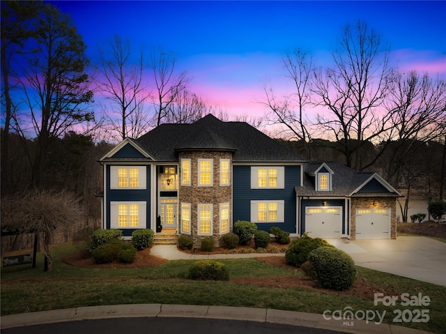 228 Wildwood Cove Dr, Mooresville, NC 28117 - view of front of property with concrete driveway, a garage, stone siding, a shingled roof, and a front yard