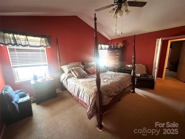 bedroom with vaulted ceiling, ceiling fan, and carpet flooring