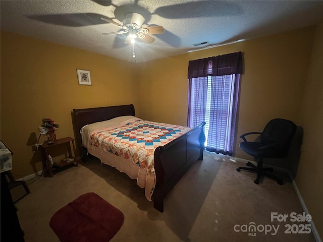 bedroom with a ceiling fan, a textured ceiling, visible vents, and carpet flooring