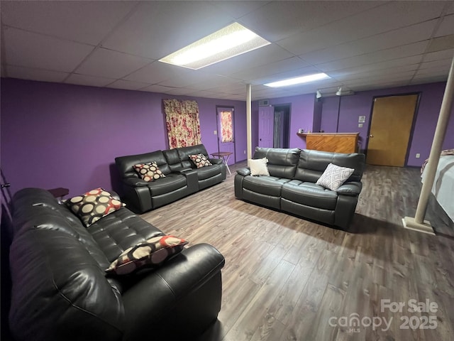 home theater room with a drop ceiling and wood finished floors