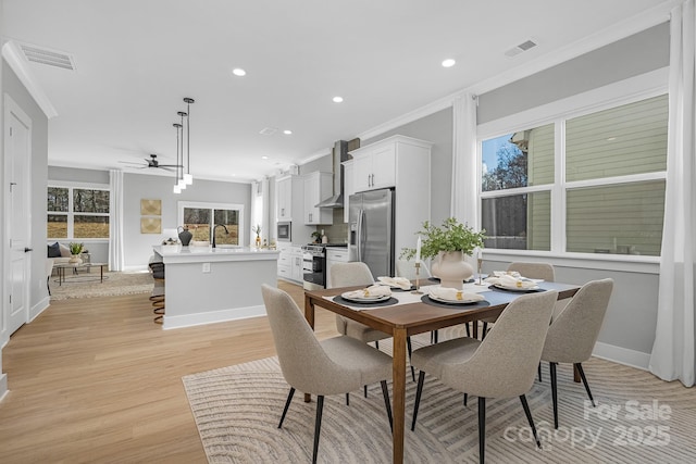 dining room featuring light wood-style floors, recessed lighting, visible vents, and ornamental molding