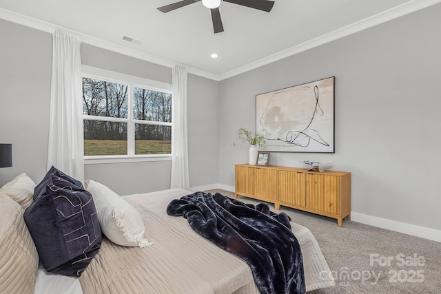 bedroom with ceiling fan, visible vents, baseboards, carpet, and crown molding