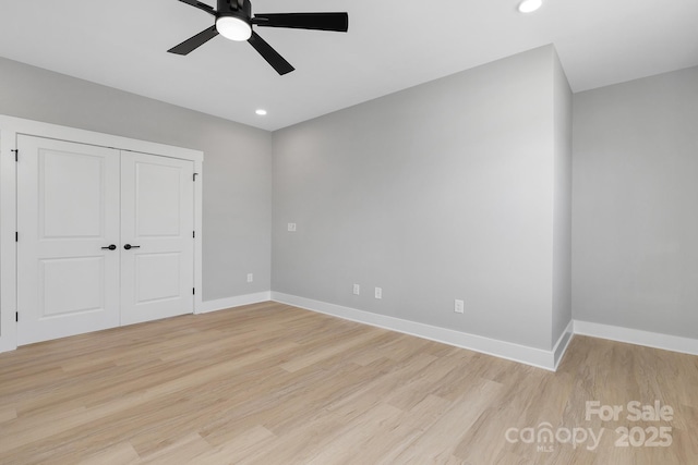 unfurnished bedroom with recessed lighting, a closet, light wood-style flooring, and baseboards