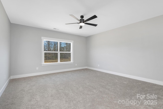 spare room with carpet flooring, ceiling fan, and baseboards