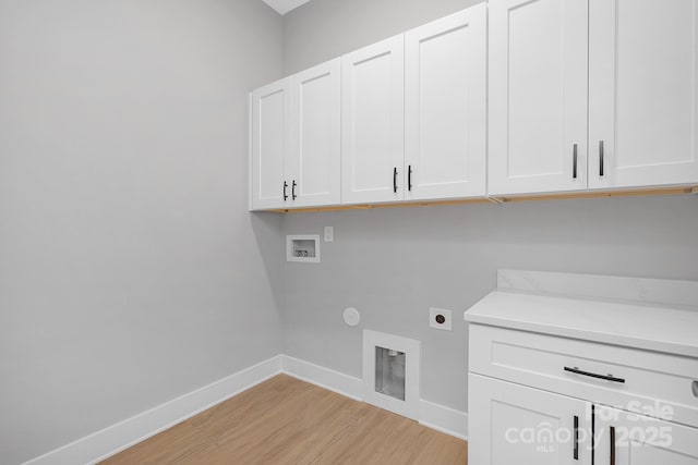 laundry area featuring washer hookup, cabinet space, light wood-style floors, hookup for an electric dryer, and baseboards