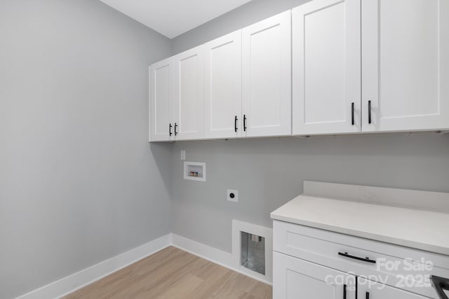 laundry room with hookup for an electric dryer, washer hookup, baseboards, light wood-type flooring, and cabinet space