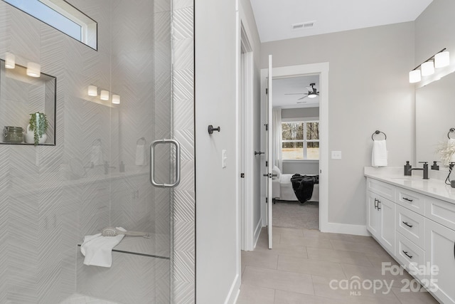 full bath with ensuite bathroom, tile patterned flooring, vanity, visible vents, and a tile shower