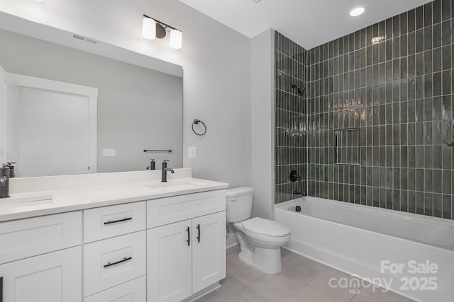 bathroom featuring double vanity, toilet, tile patterned flooring, bathtub / shower combination, and a sink