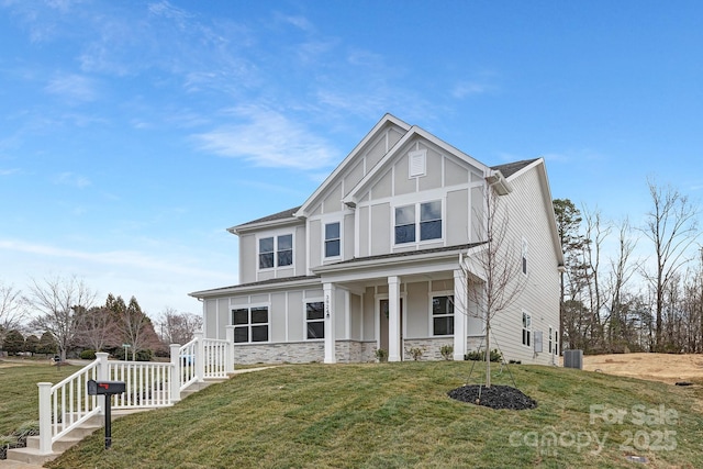 view of front of property with stone siding and a front yard