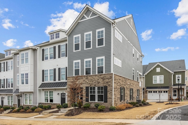 townhome / multi-family property featuring brick siding, board and batten siding, and cooling unit