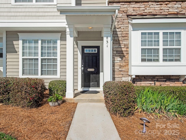 entrance to property featuring stone siding