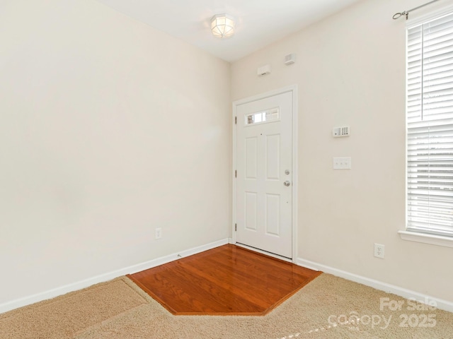 foyer entrance featuring baseboards