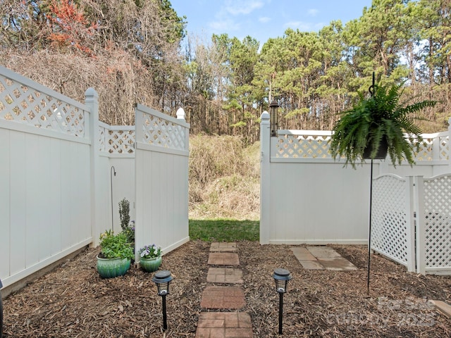 view of gate with fence