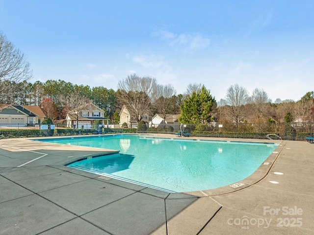 pool featuring a patio area and fence