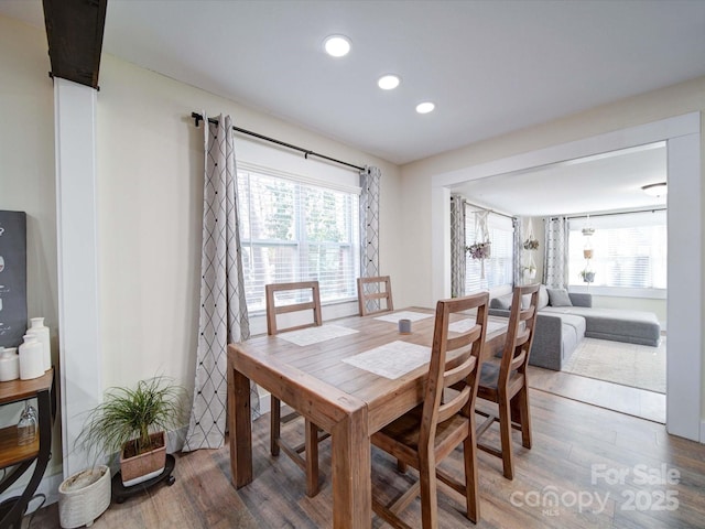 dining space with wood finished floors and recessed lighting