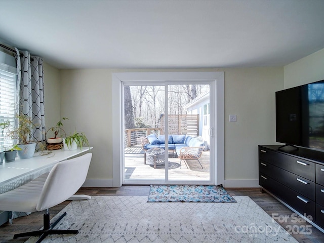 home office featuring baseboards and dark wood finished floors