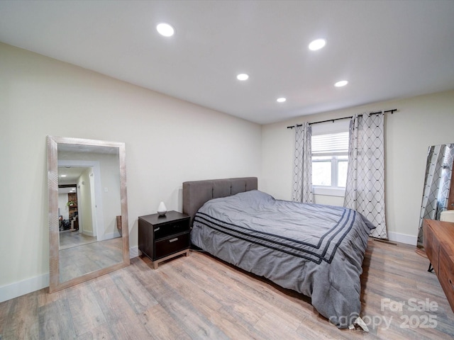 bedroom with recessed lighting, baseboards, and wood finished floors