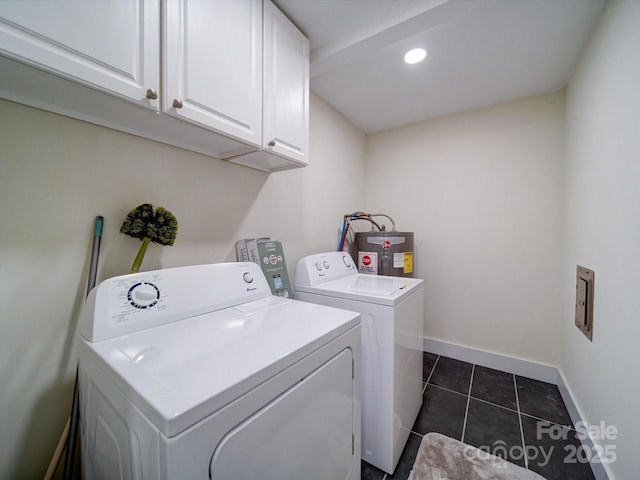 clothes washing area featuring cabinet space, electric water heater, washer and dryer, dark tile patterned floors, and baseboards