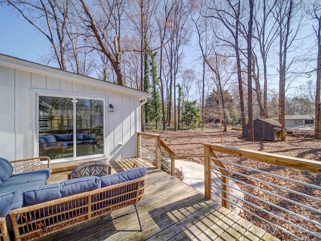 wooden deck with a storage shed, an outdoor structure, and an outdoor living space