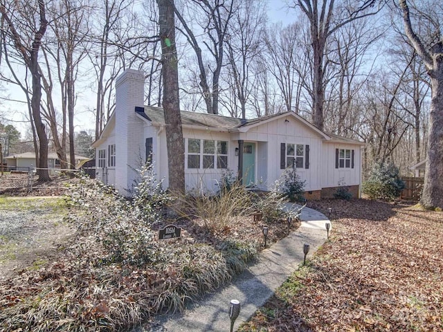 ranch-style house with crawl space, a chimney, and fence