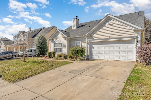 view of front of home with an attached garage, concrete driveway, roof with shingles, a chimney, and a front yard