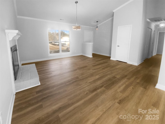 unfurnished living room with dark wood finished floors, a fireplace, and crown molding