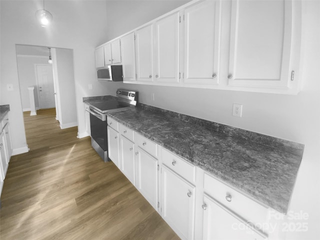 kitchen featuring stainless steel appliances, white cabinets, baseboards, and dark wood-style floors