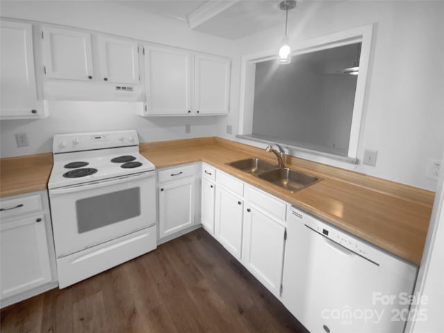 kitchen featuring white appliances, decorative light fixtures, light countertops, white cabinetry, and a sink