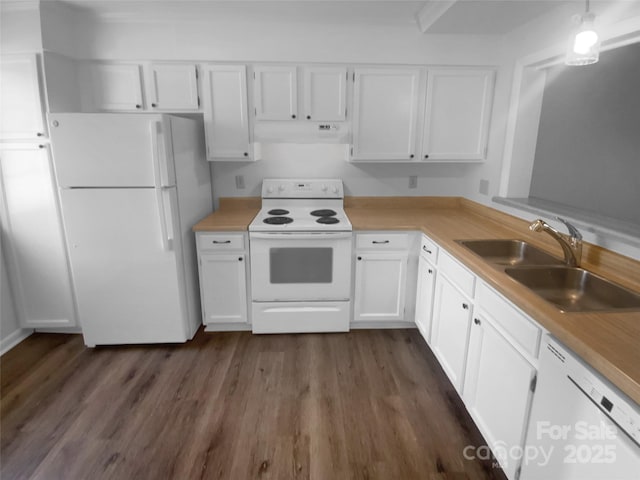 kitchen with light countertops, white appliances, a sink, and white cabinetry