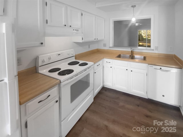 kitchen featuring under cabinet range hood, white appliances, a sink, hanging light fixtures, and light countertops