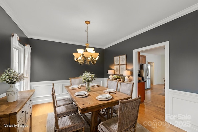 1919 46th Avenue Dr NE Unit 46, Hickory, NC 28601 - dining area featuring a wainscoted wall, ornamental molding, light wood-style flooring, a chandelier, and a decorative wall