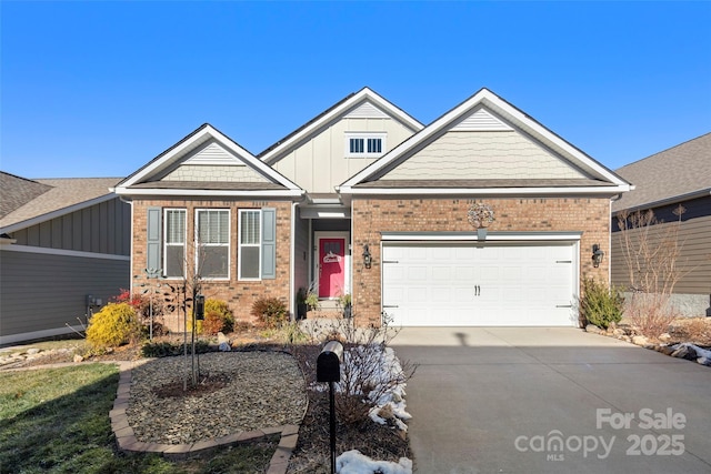 view of front of house with a garage, driveway, brick siding, and board and batten siding