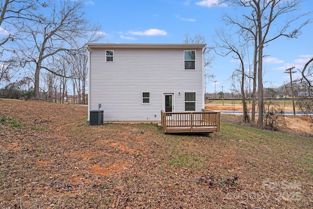 back of property with a deck and cooling unit