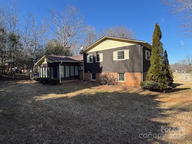 exterior space featuring brick siding and a lawn