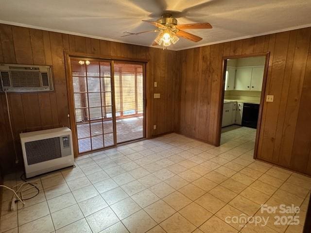 spare room with ceiling fan, wood walls, ornamental molding, a wall mounted AC, and heating unit