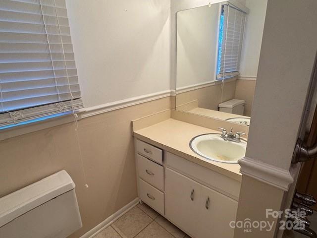 bathroom featuring vanity, toilet, and tile patterned floors