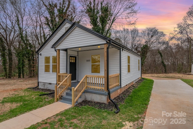 shotgun-style home featuring a porch and crawl space