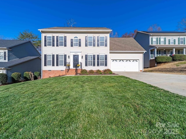 colonial-style house featuring a front yard, crawl space, an attached garage, and concrete driveway