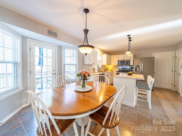 dining space featuring baseboards