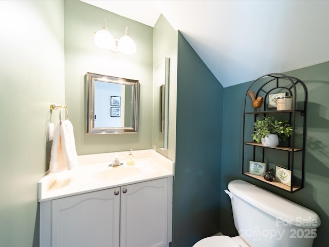 bathroom featuring toilet and vanity