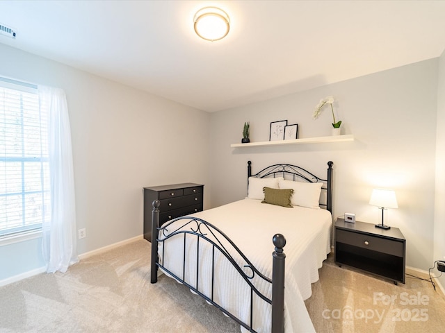 bedroom with visible vents, baseboards, and light colored carpet