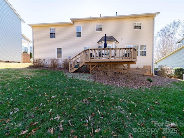 rear view of house with a yard, stairway, and a wooden deck