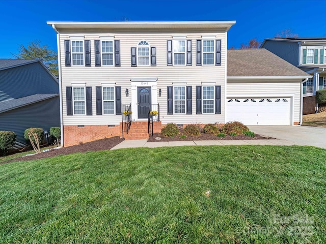 colonial house with crawl space, an attached garage, a front lawn, and concrete driveway