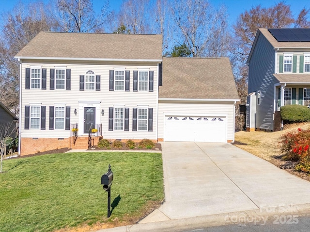 colonial inspired home with roof with shingles, concrete driveway, an attached garage, a front yard, and crawl space