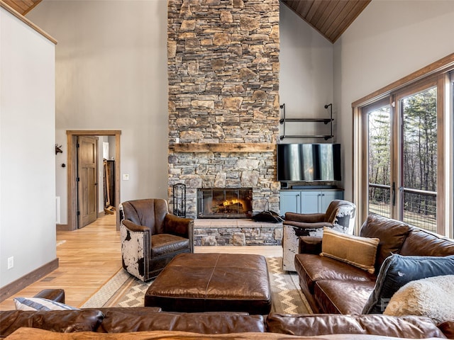 103 Duck Hope Dr, Hendersonville, NC 28739 - living room featuring high vaulted ceiling, light wood-style flooring, baseboards, and a stone fireplace