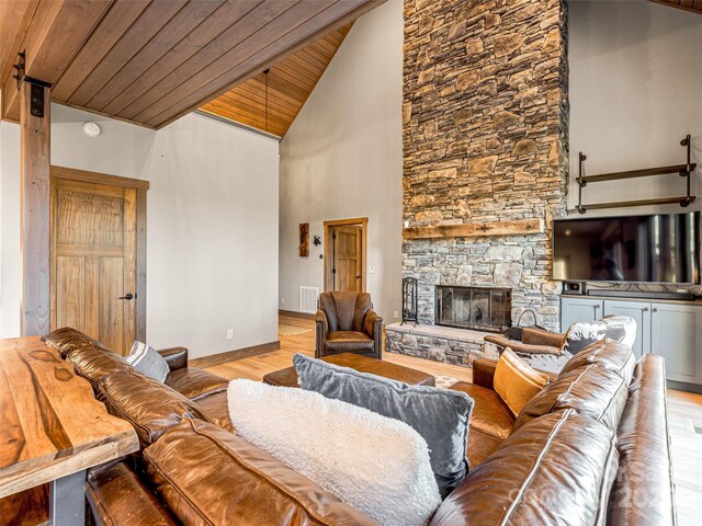 103 Duck Hope Dr, Hendersonville, NC 28739 - living area featuring a stone fireplace, wooden ceiling, wood finished floors, visible vents, and vaulted ceiling
