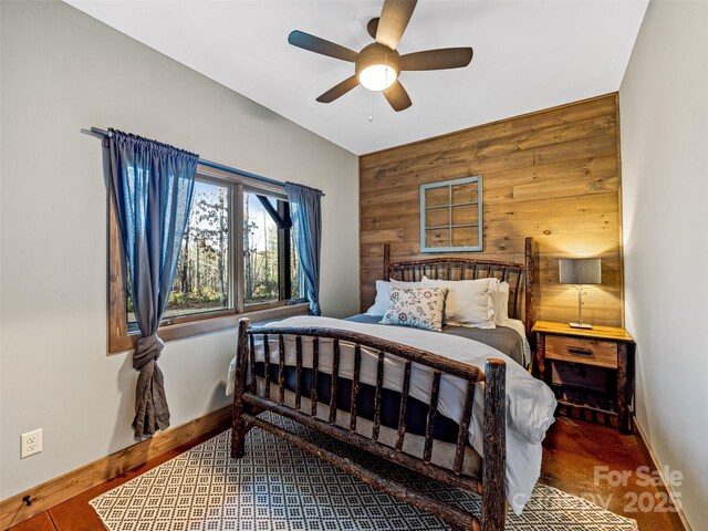 103 Duck Hope Dr, Hendersonville, NC 28739 - bedroom featuring wood walls, an accent wall, baseboards, and a ceiling fan