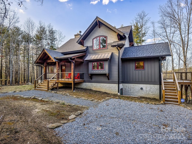 103 Duck Hope Dr, Hendersonville, NC 28739 - view of front of home featuring a shingled roof, a chimney, covered porch, stairs, and board and batten siding